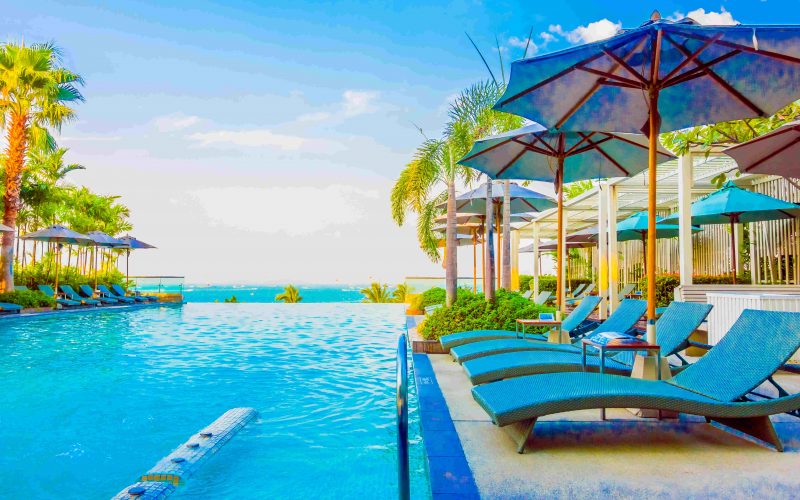 Beautiful luxury swimming pool with umbrella and chair in luxury hotel resort - Boost up color Processing style