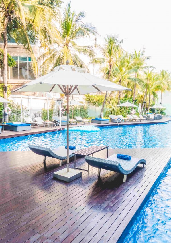 Umbrella pool and chair around beautiful luxury swimming pool in hotel resort - Vintage Light film Filter